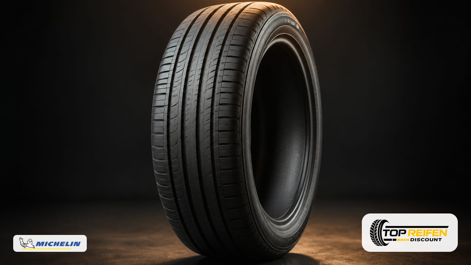 Studioaufnahme: Ein MICHELIN E-PRIM 175/65 R17 Sommerreifen steht auf dunkler, spiegelnder Fläche. Weiches Kantenlicht zeichnet Profil und Seitenwand, minimalistischer Look.